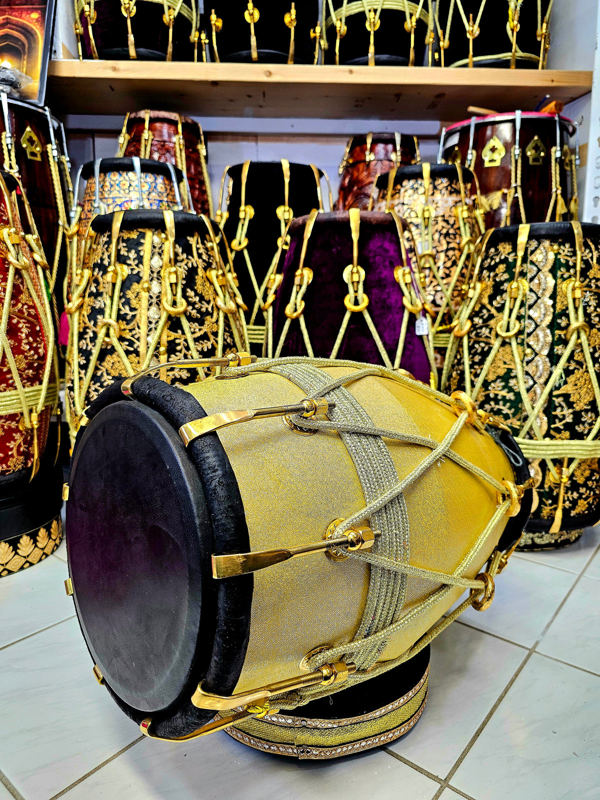 Radiant Rhythms: Golden Sparkly Wrapped Red Sheesham Dholak with Black Skins, Thin-Rimmed Treble Skin, and Golden Accents - *Slightly Imperfect Wrap