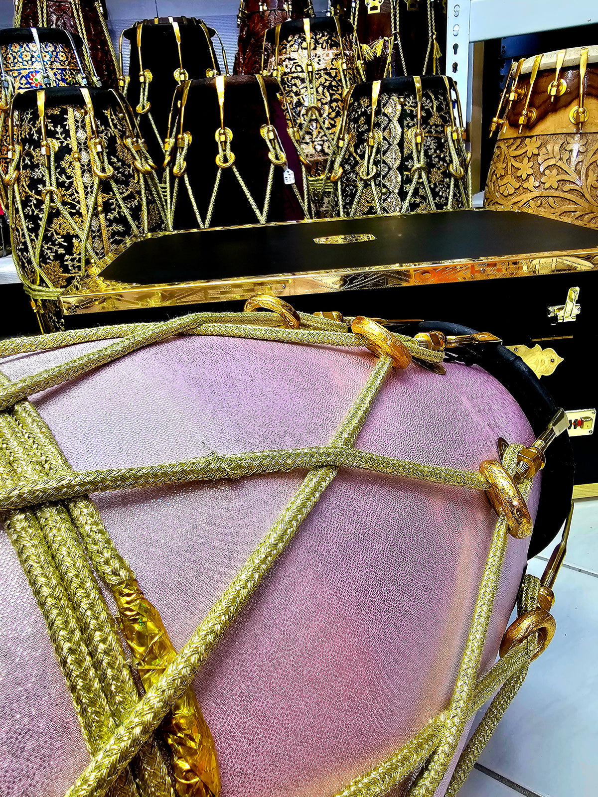 Enchanting Blush Sparkle: Red Sheesham Dholak in Sparkly Pink Wrap, Black Skins, Golden Brass Accents, and Intricate Golden Ropes