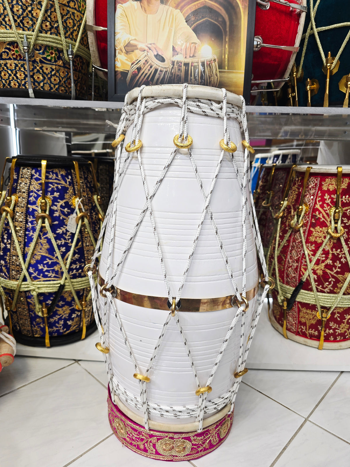 Ivory Current – West Indian Dholak
22.5″ Length | 14.4 lbs Red Sheesham | Exceptional Tone • Minor Cosmetic Blemishes