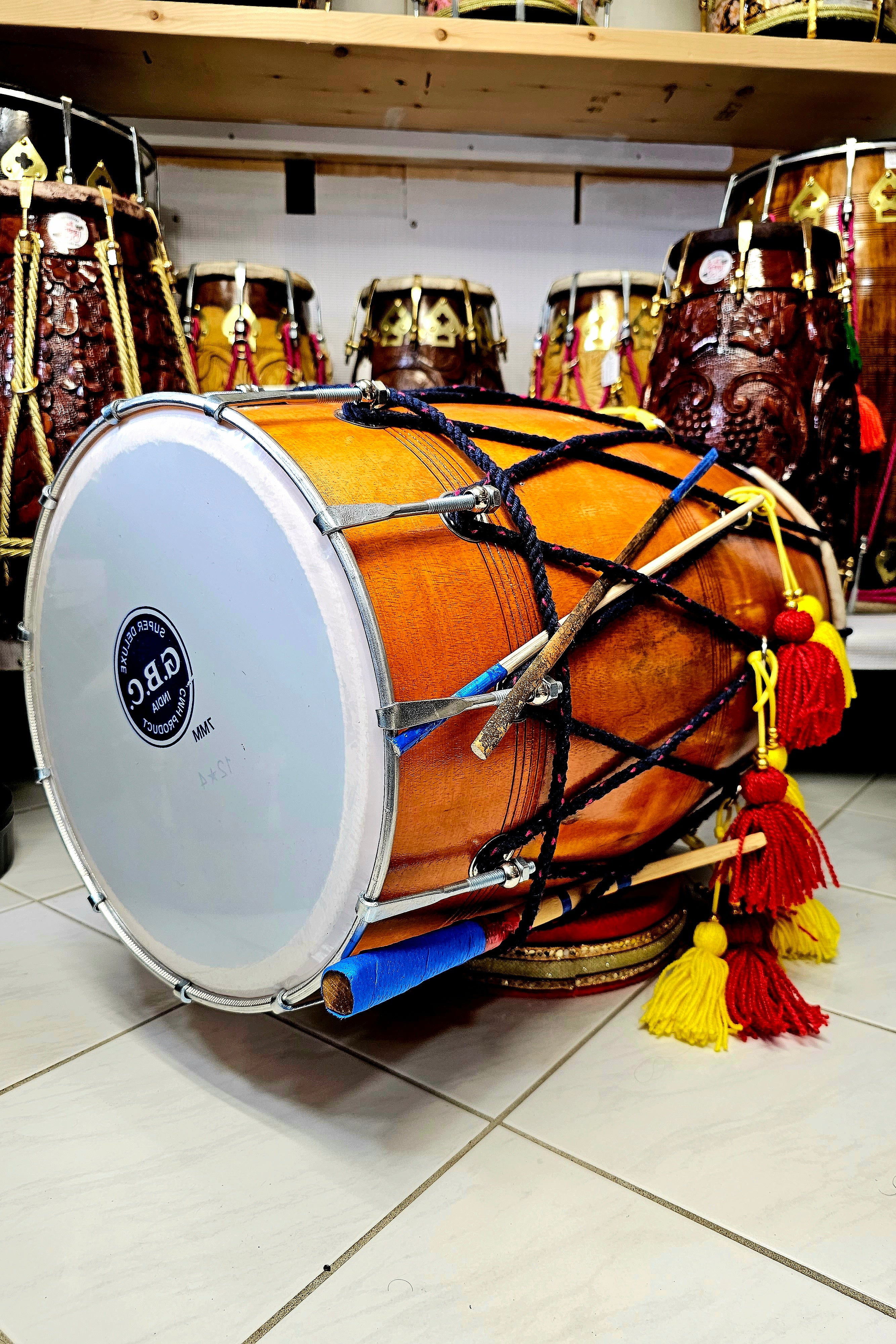 The Punjabi Fusion Pro Dhol - A Natural Mango Wood Dhol with Red and Yellow Tassels, Black Ropes, and Chrome Bolts!