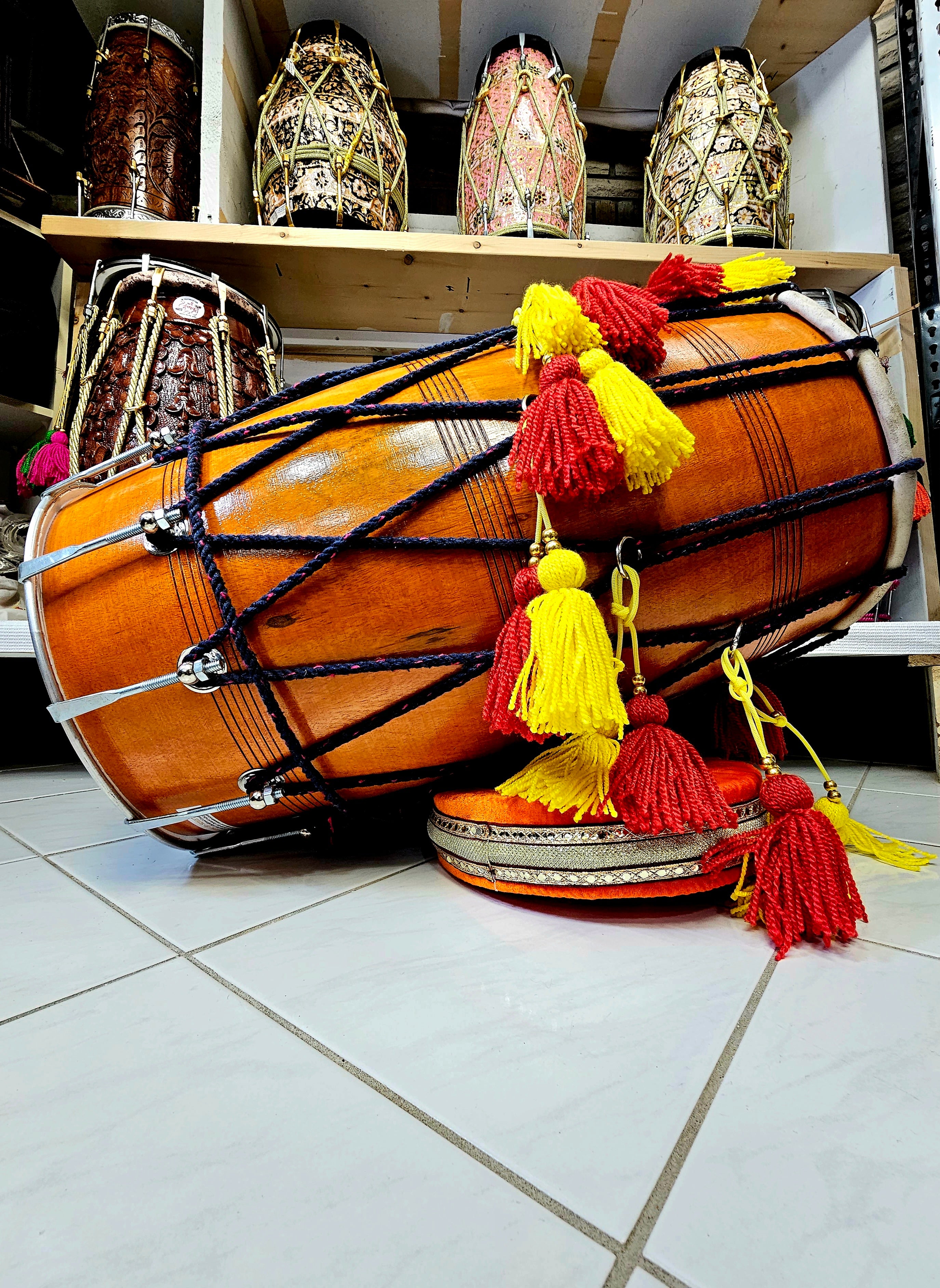 The Punjabi Fusion Pro Dhol - A Natural Mango Wood Dhol with Red and Yellow Tassels, Black Ropes, and Chrome Bolts!