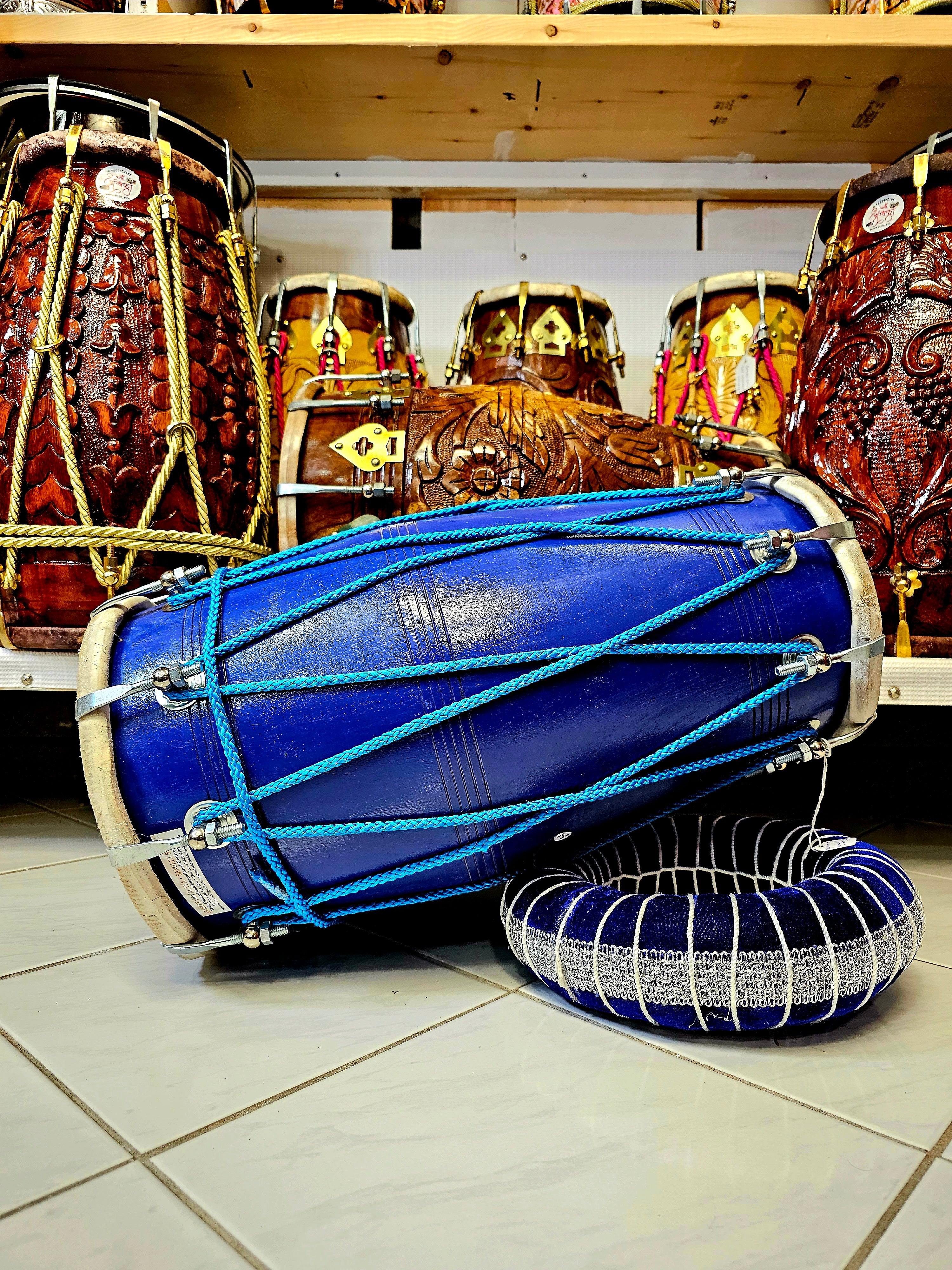 The Cobalt Crescendo Pro Dholak - A Blue Professional Dholak with Chrome Bolts and Striking Blue Ropes Design!