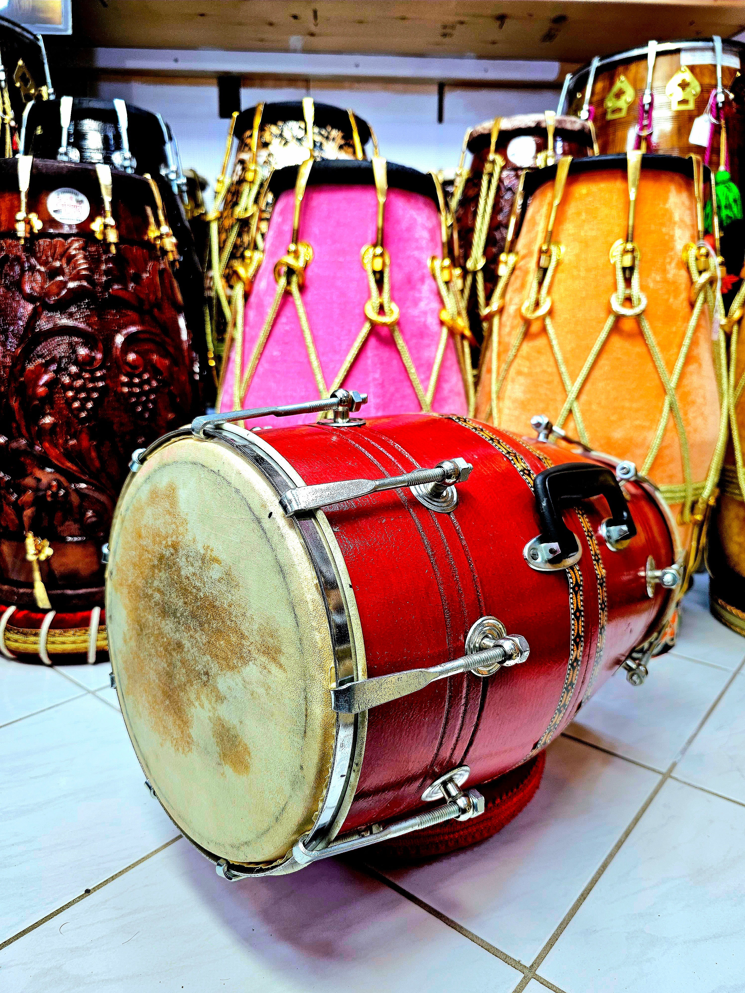 Crimson Cadence: Red Student Quality Dholak with Chrome Bolts, Metal Rim, and Handle