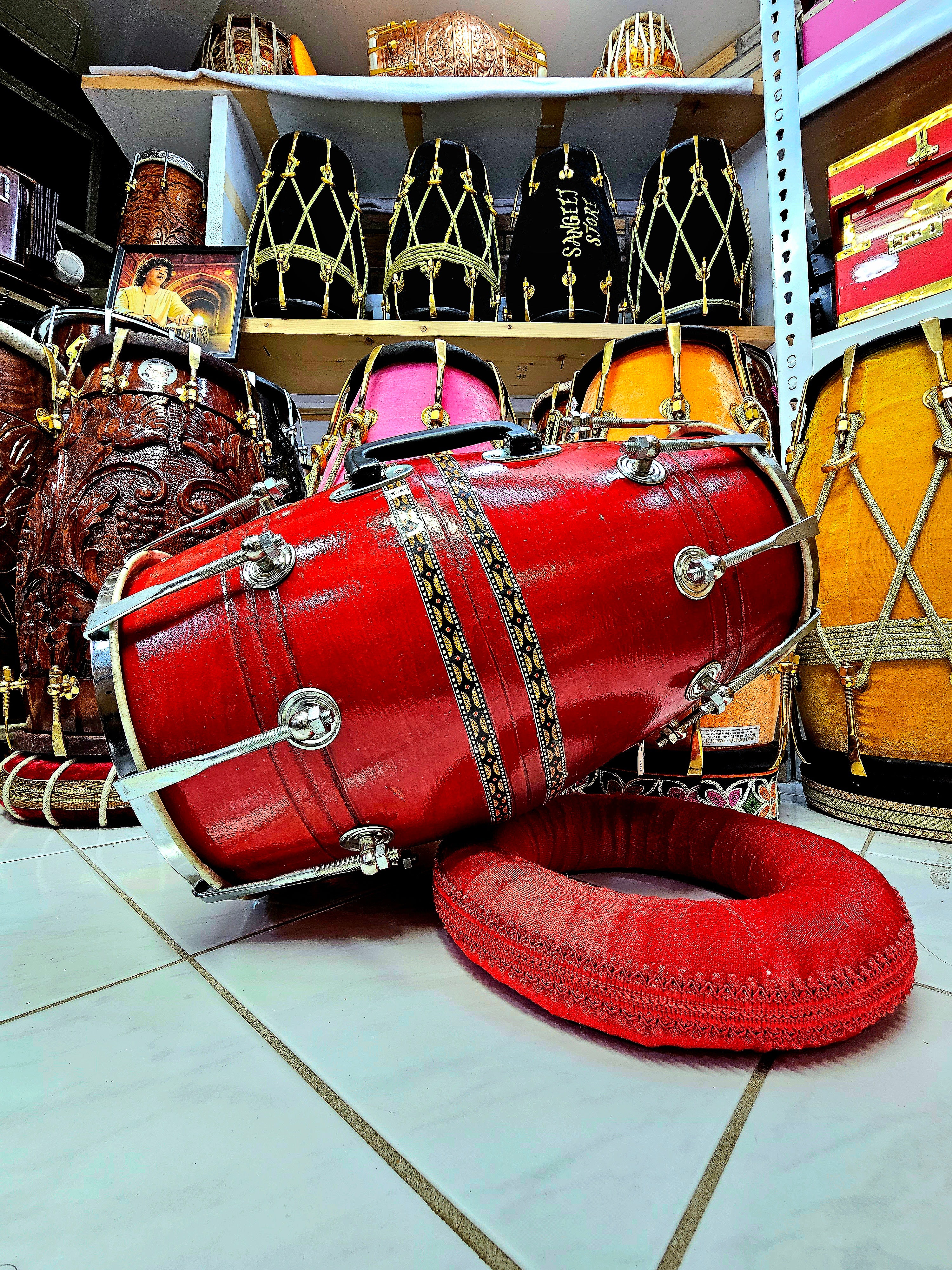 Crimson Cadence: Red Student Quality Dholak with Chrome Bolts, Metal Rim, and Handle