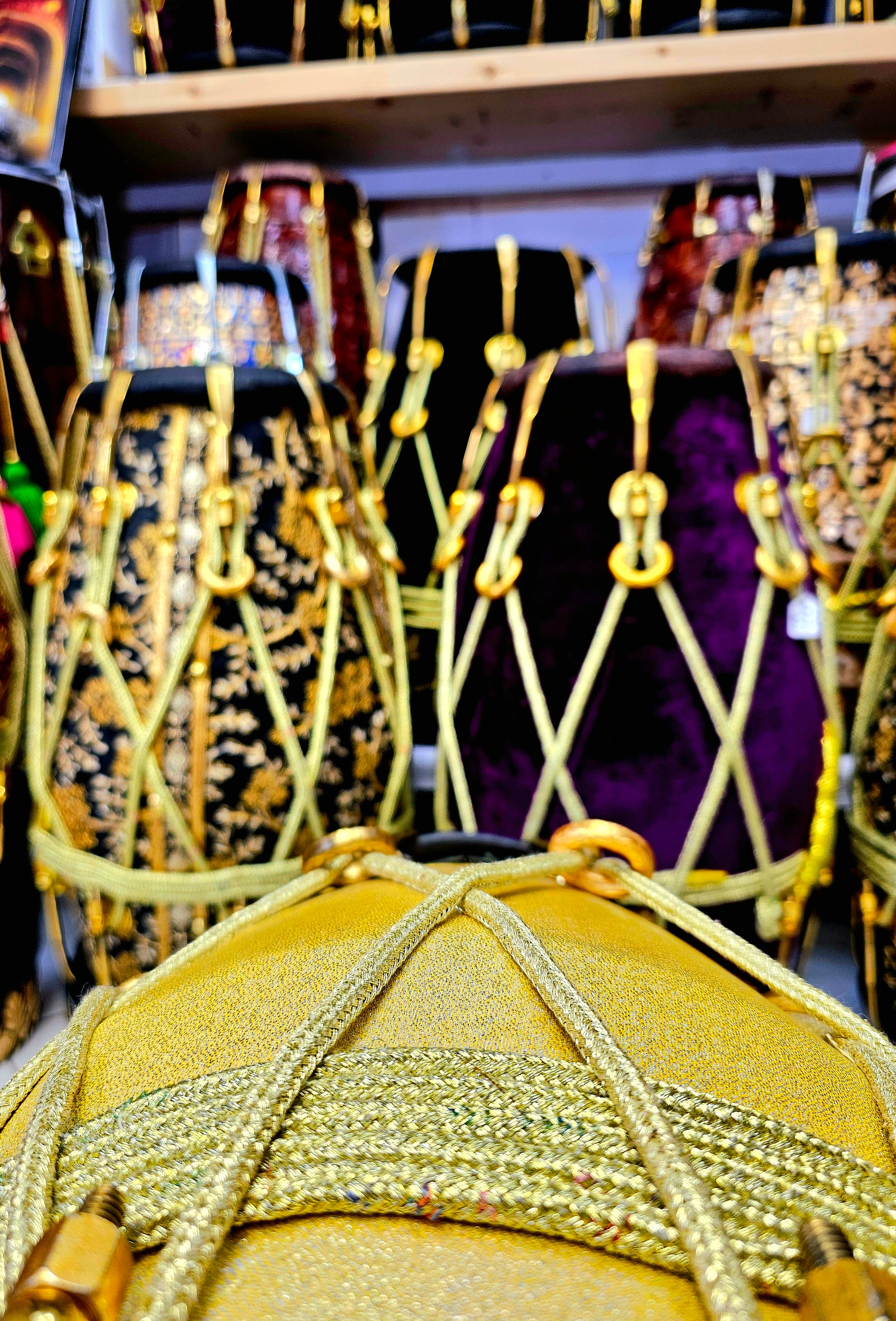 Radiant Rhythms: Golden Sparkly Wrapped Red Sheesham Dholak with Black Skins, Thin-Rimmed Treble Skin, and Golden Accents - *Slightly Imperfect Wrap