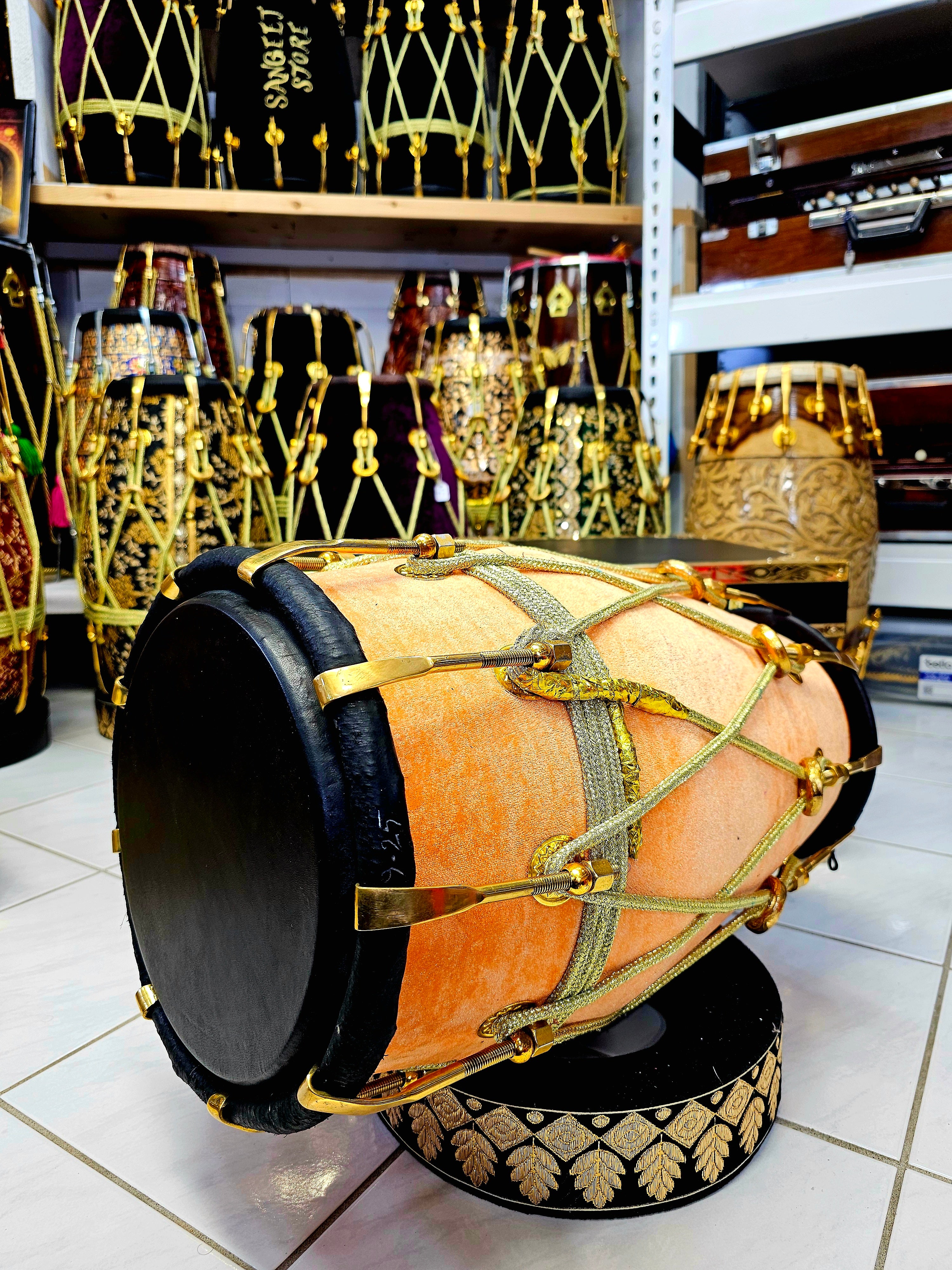 Peach Melody: Red Sheesham Dholak in Peach Velvet Wrap, Black Skins, Golden Brass Accents, and Intricate Rope Design