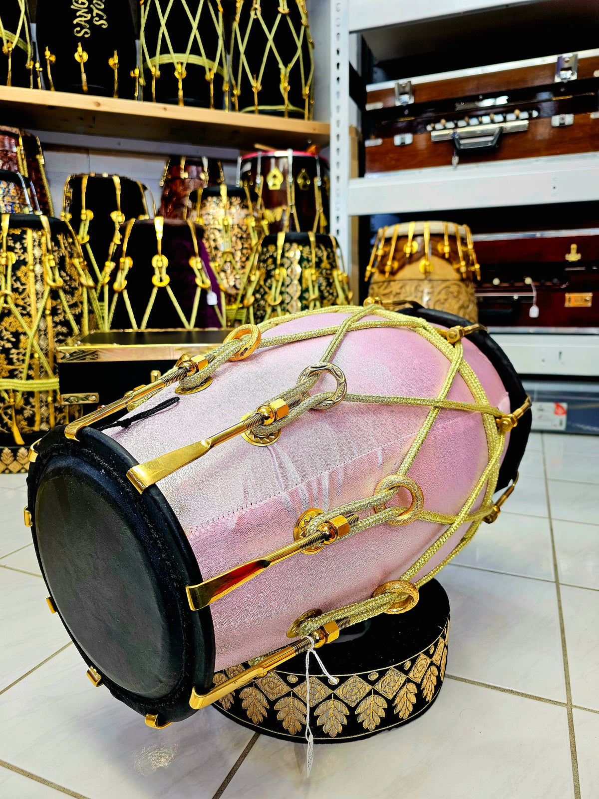 Enchanting Blush Sparkle: Red Sheesham Dholak in Sparkly Pink Wrap, Black Skins, Golden Brass Accents, and Intricate Golden Ropes