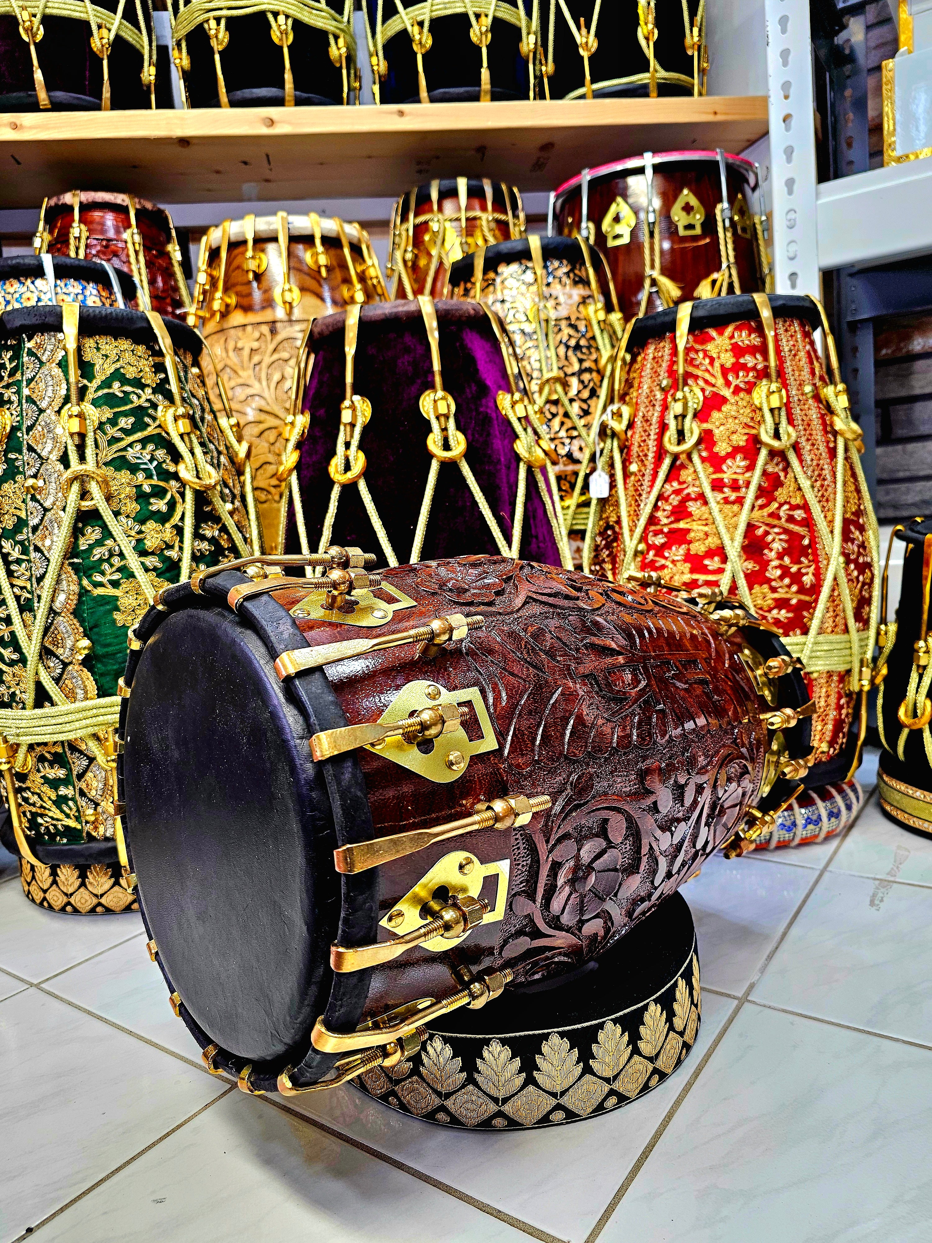 Prem's Florid Echo: Custom Floral Engraved Black Sheesham Dholak with Brass Bolts and Ebony Black Skin (Includes 2 Extra Concert Quality Skins ($50 Each))