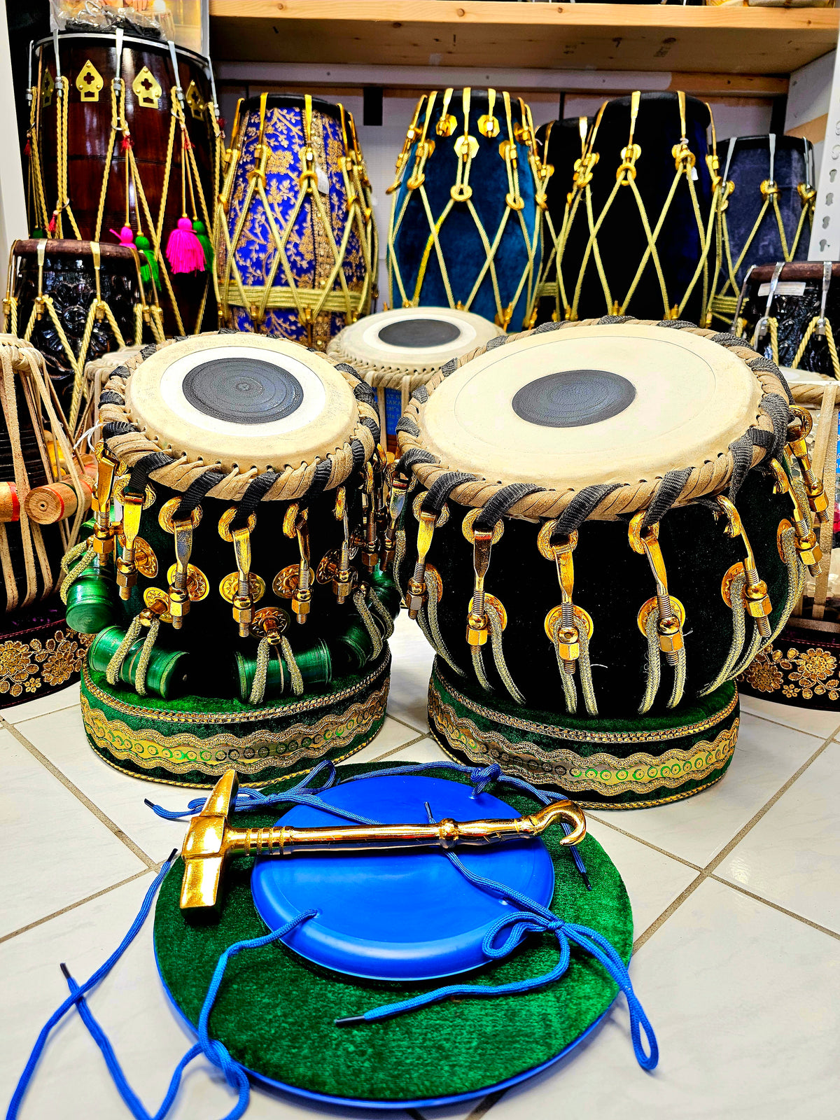 Emerald Harmony Tabla Set: 6" C/C#/D Red Sheesham Dayan + 9.25" Copper Bayan, elegantly wrapped in green velvet and featuring premium golden pure brass bolts.