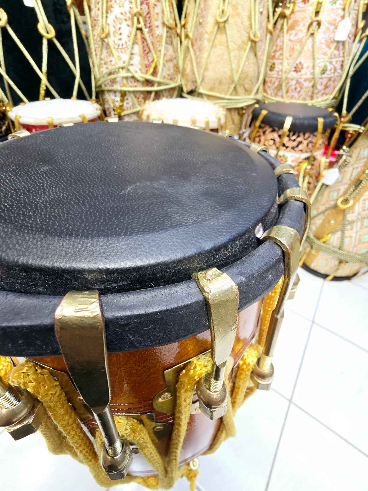 Golden Echo: Traditional Red Sheesham Professional Double Bolted Dholak with Golden Coated Brass Bolts, Black Skins, and Yellow Ropes Design