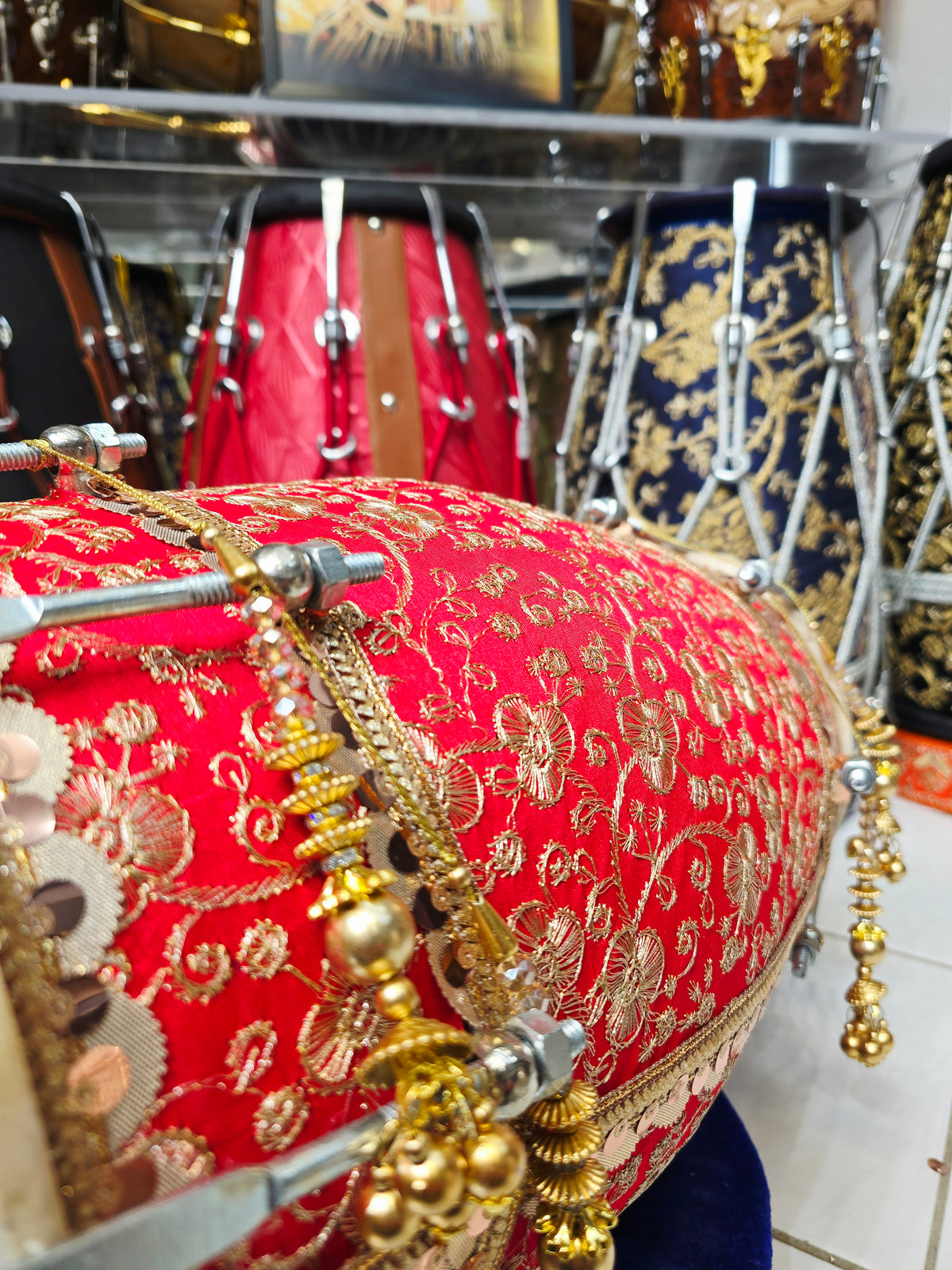 Rang Mahal – Royal Scarlet & Gold Floral Sherwani-Wrapped Designer Mehendi Night Dholak with Decorative Golden Ornaments