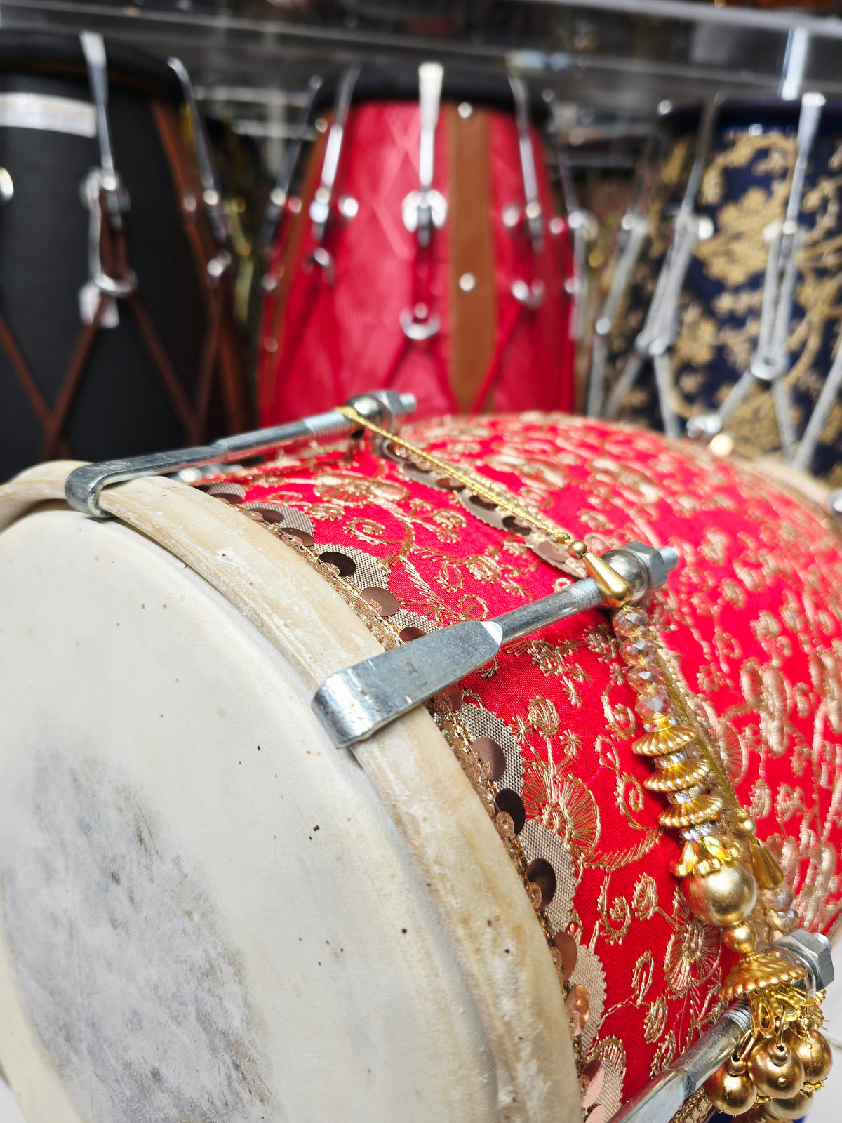 Rang Mahal – Royal Scarlet & Gold Floral Sherwani-Wrapped Designer Mehendi Night Dholak with Decorative Golden Ornaments